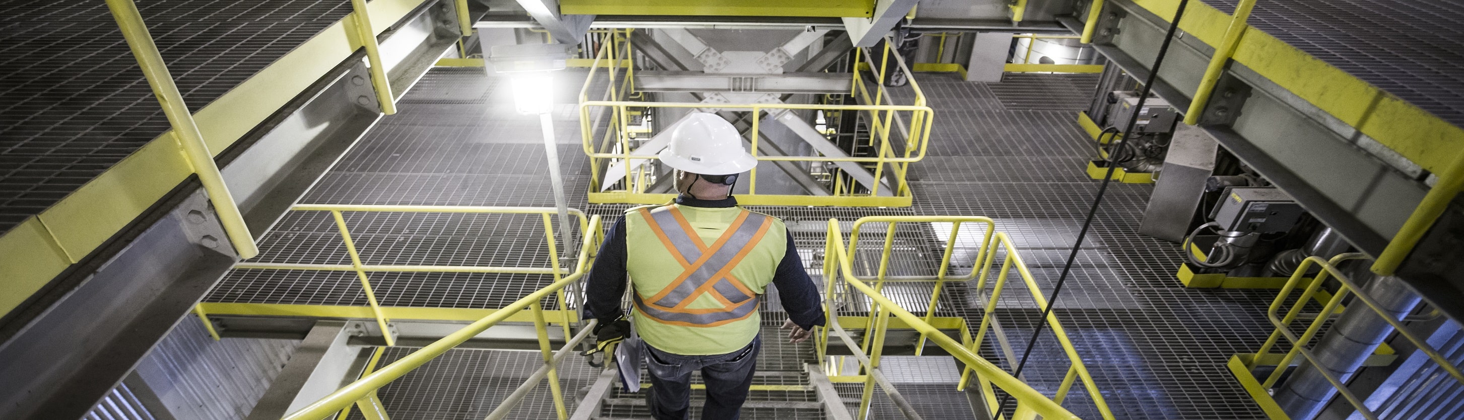 Worker walking down stairs inside the Durham York Energy Centre